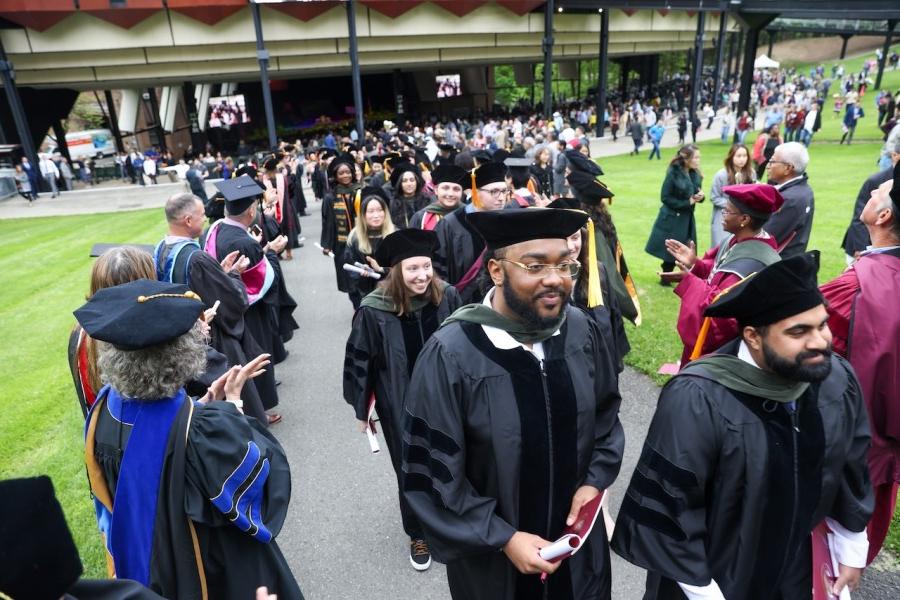 Graduates walk out of commencement ceremony